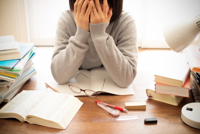 勉強中に頭を抱え込む女の子