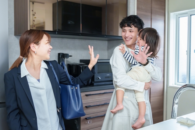 おとうさんが子供を家で見て仕事へ出かけるお母さん